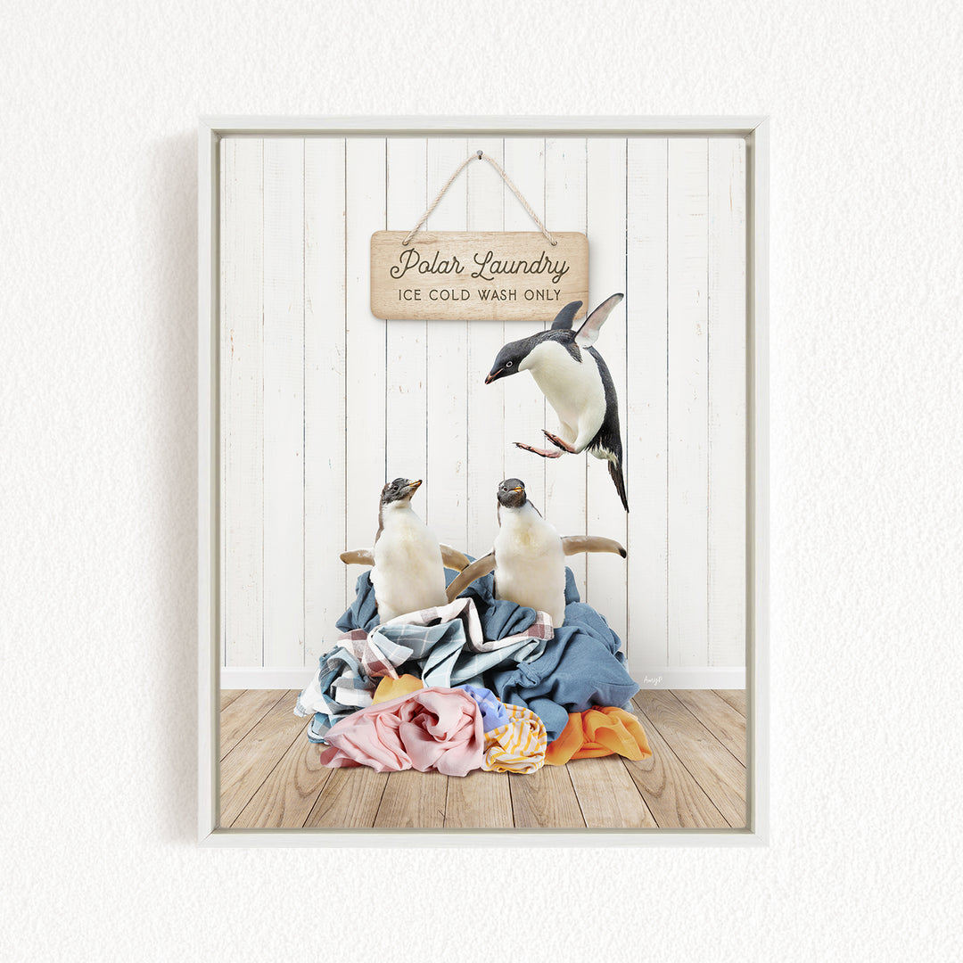 A framed image depicting three penguins on a pile of clothes, with a sign that reads "Polar Laundry Ice Cold Wash Only".