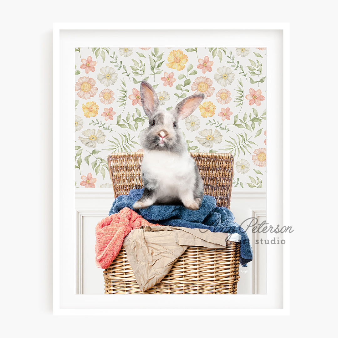 a rabbit sitting on top of a wicker basket