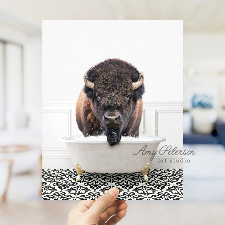 a person holding up a card with a picture of a bison in a bathtub