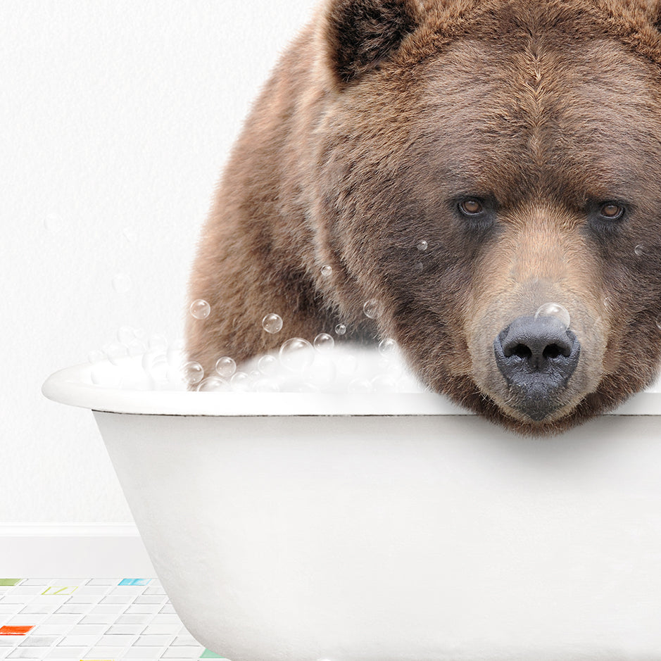 a brown bear taking a bath in a bathtub