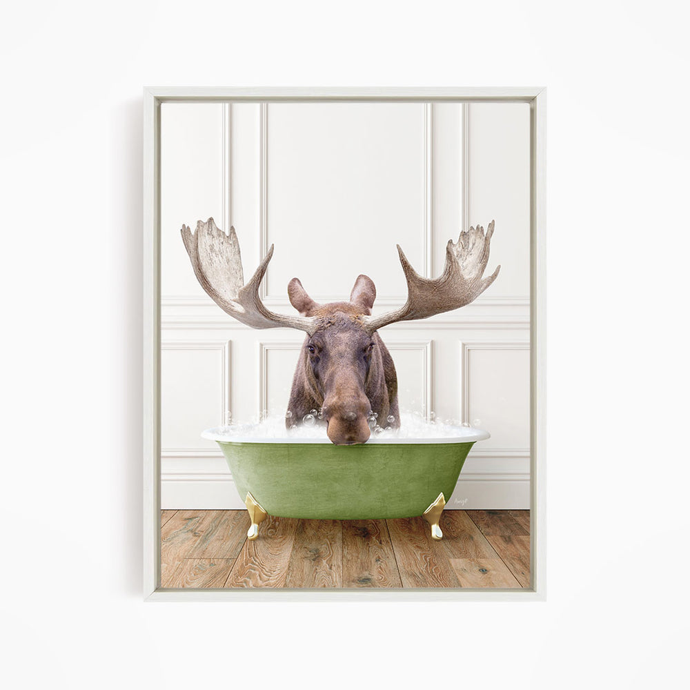 A moose with large antlers is sitting in a green bathtub filled with water, creating a whimsical and humorous scene.