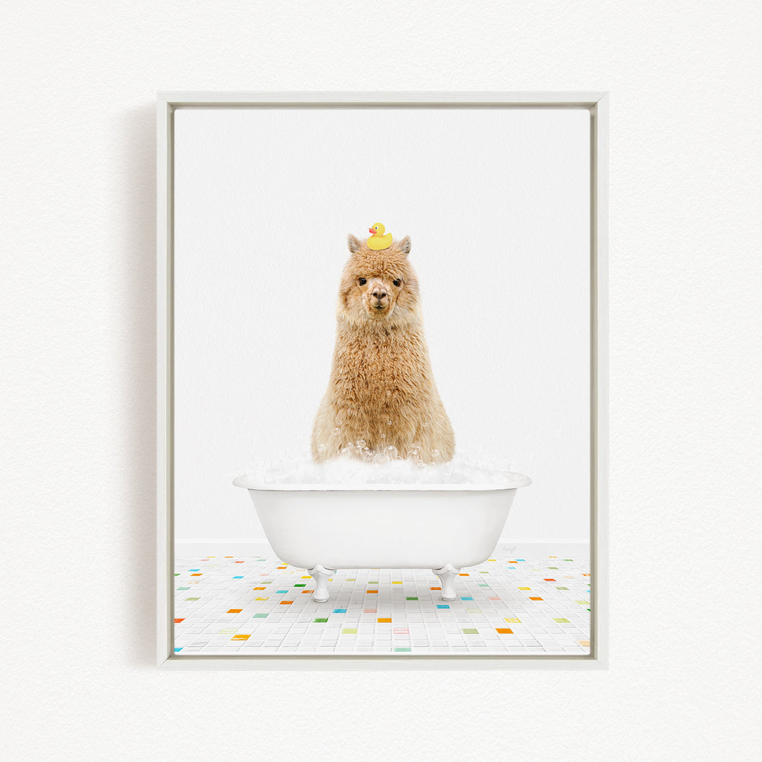 A fluffy brown llama sits in a white bathtub filled with bubbles, wearing a yellow hat.
