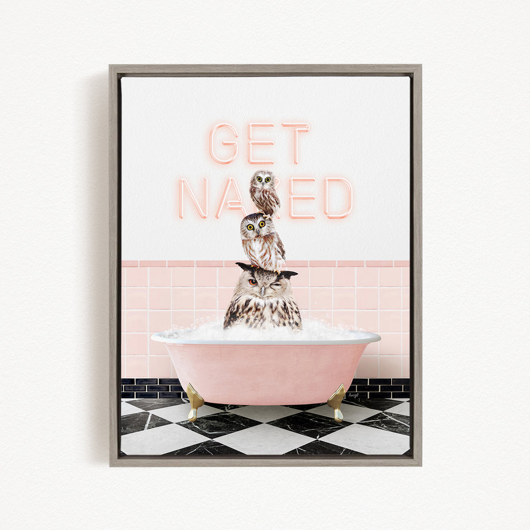 A framed print featuring a whimsical image of three owls sitting in a pink bathtub, with the text "GET NAUGED" displayed above them.
