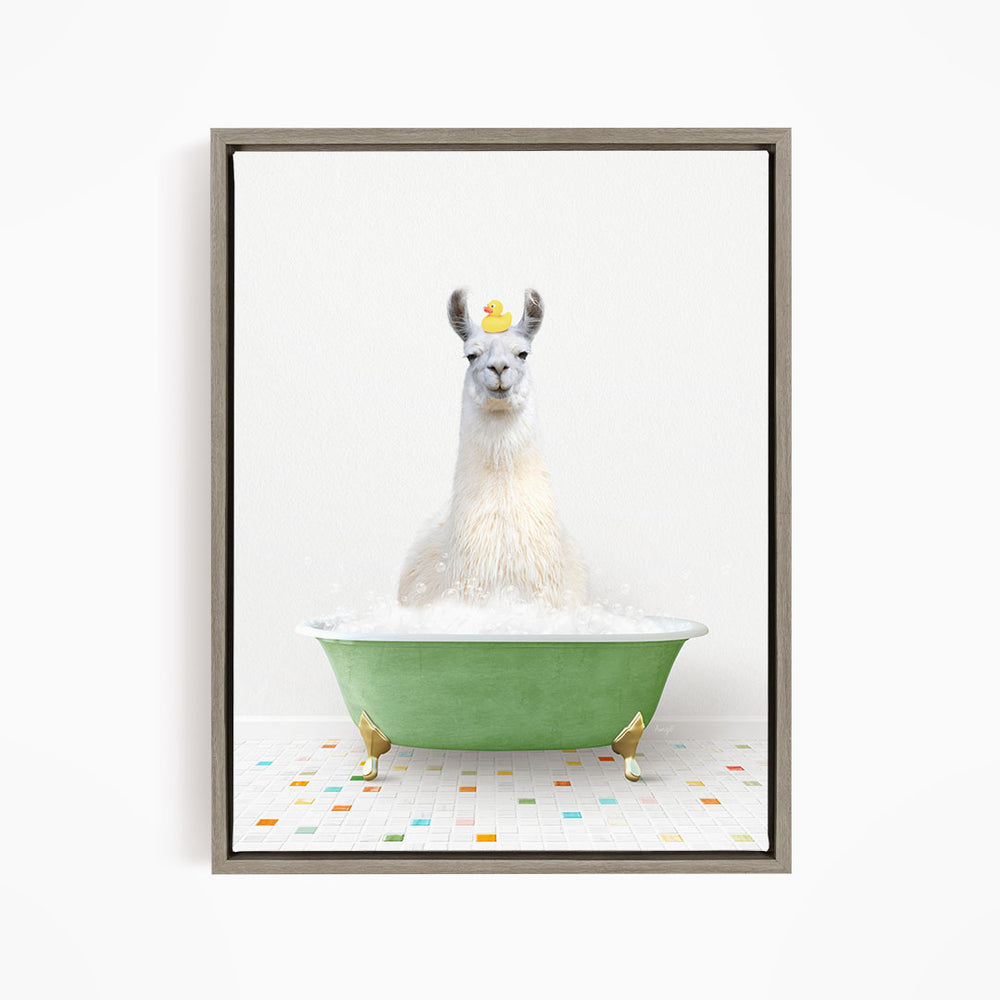 A white llama sitting in a green bathtub filled with bubbles, with a yellow rubber duck floating on its head.