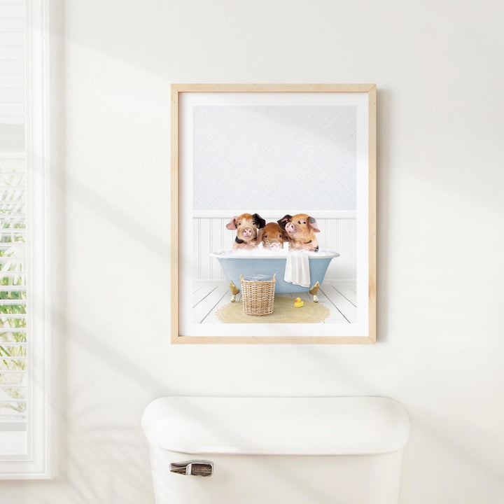 A framed image of three adorable hamsters sitting in a bathtub, with a basket of bath toys nearby.