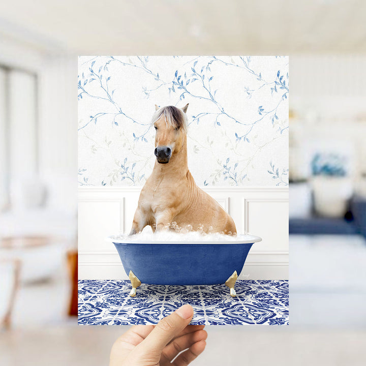 A brown horse sitting in a blue bathtub filled with water, surrounded by a blue and white floral patterned wall.