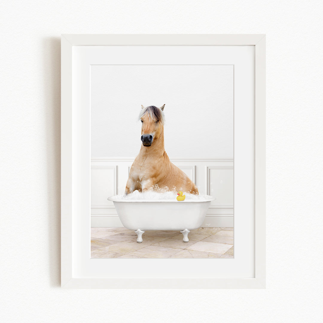 A brown horse sitting in a white bathtub filled with water, with a yellow rubber duck floating in the water.