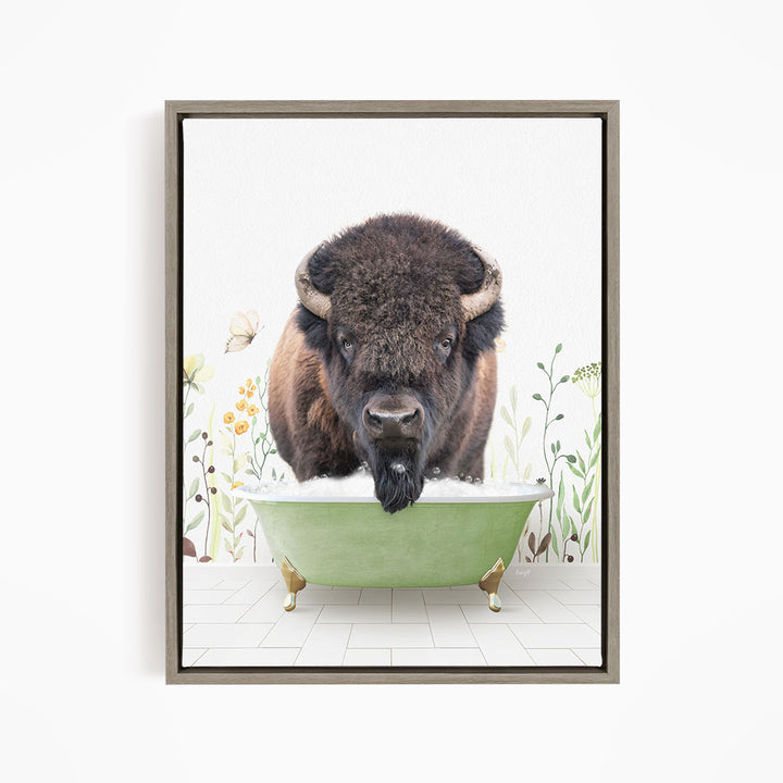 A buffalo with large horns is standing in a green bathtub, surrounded by flowers and plants.
