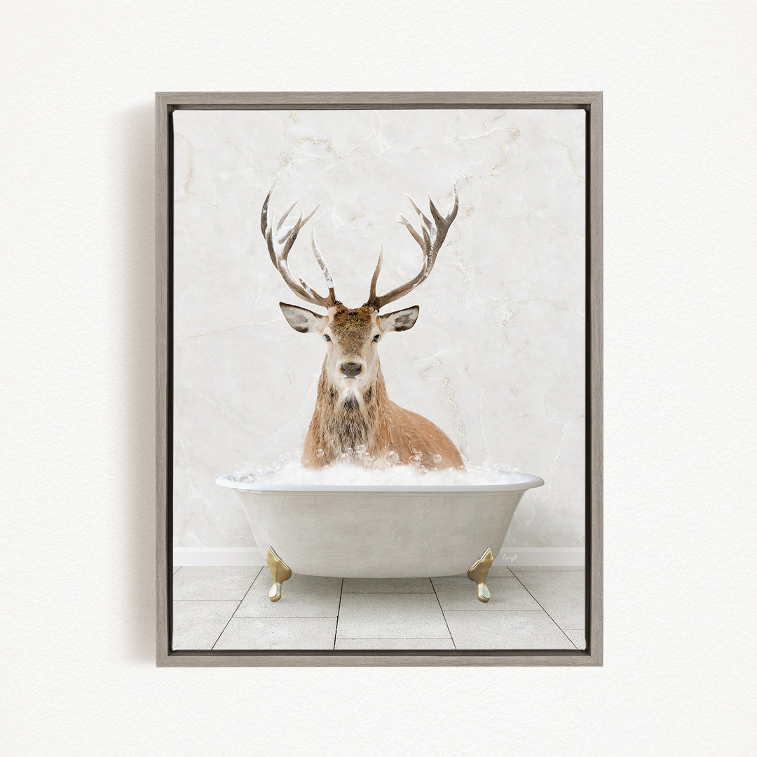 A deer with large antlers is sitting in a white bathtub filled with water, creating a whimsical and unexpected scene.