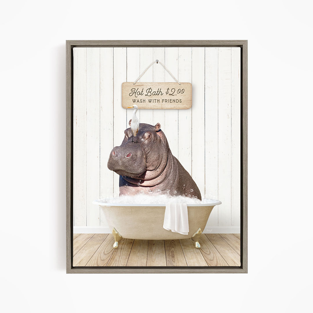 A framed image depicting a hippopotamus sitting in a bathtub, with a sign above it that reads "Hot Bath $2.00 WASH WITH FRIENDS".