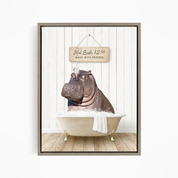 A framed image depicting a hippopotamus sitting in a bathtub, with a sign above it that reads "Hot Bath $2.00 WASH WITH FRIENDS".