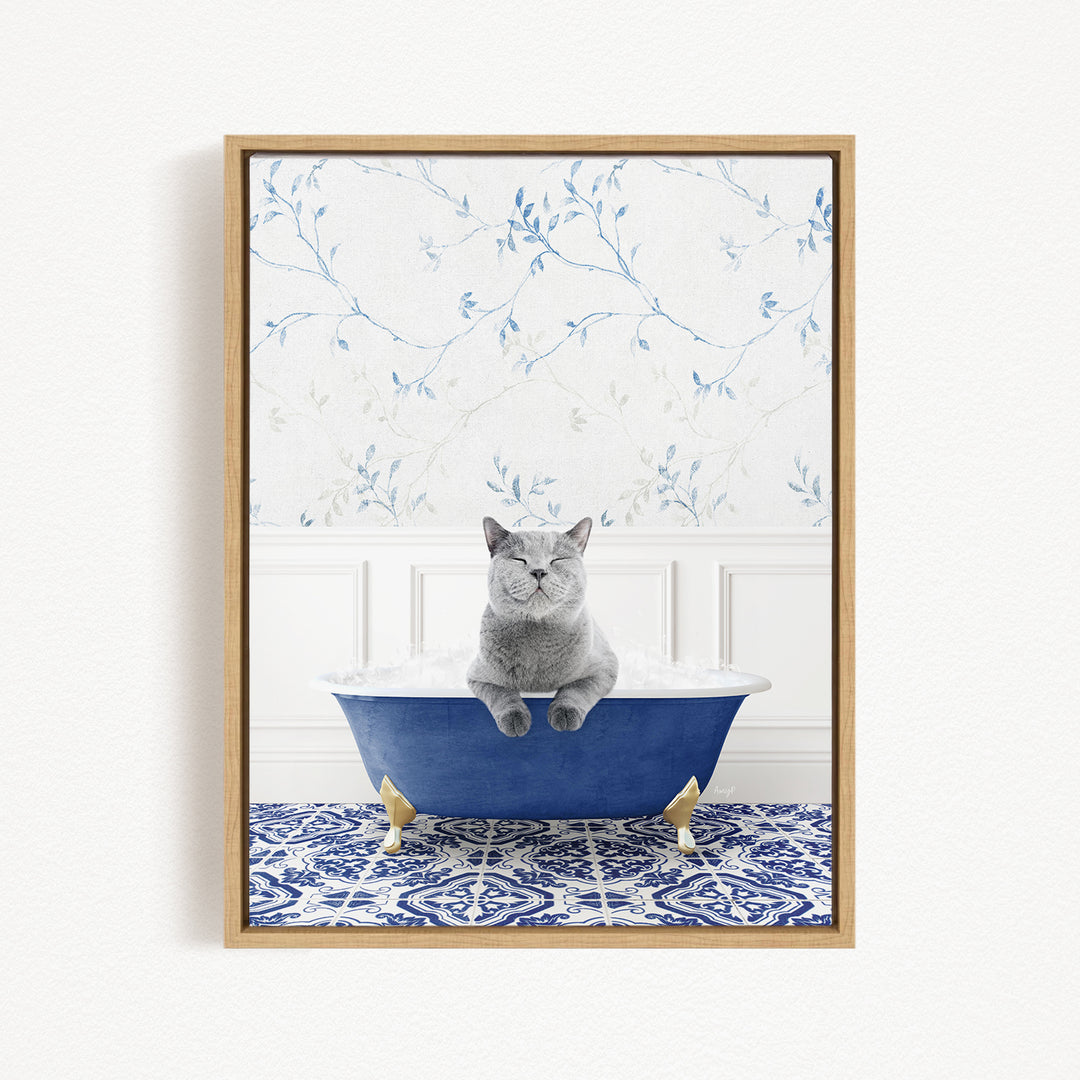 A gray cat sitting in a blue bathtub, surrounded by a patterned tile floor and a floral wallpaper background.