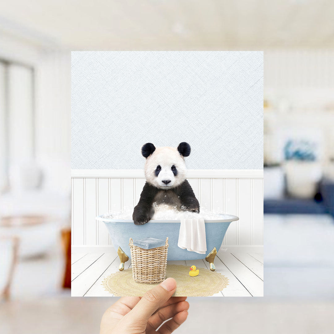 A panda bear sitting in a bathtub filled with bubbles, surrounded by a basket of toys and a yellow rubber duck.