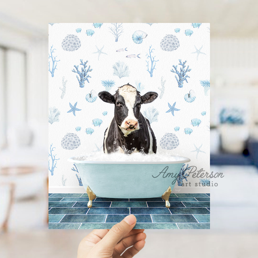 a hand holding up a card with a picture of a cow in a bathtub