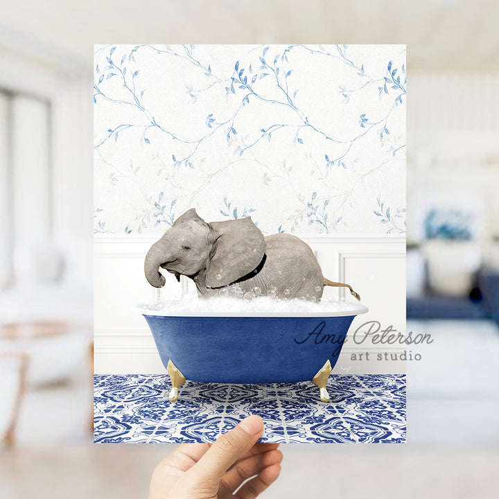 a hand holding a card with an elephant in a bathtub