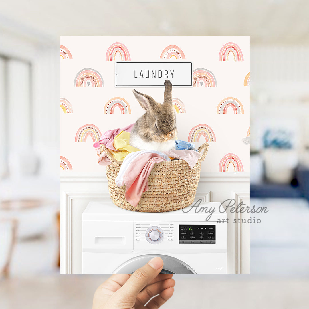 a person holding a photo of a rabbit in a laundry basket