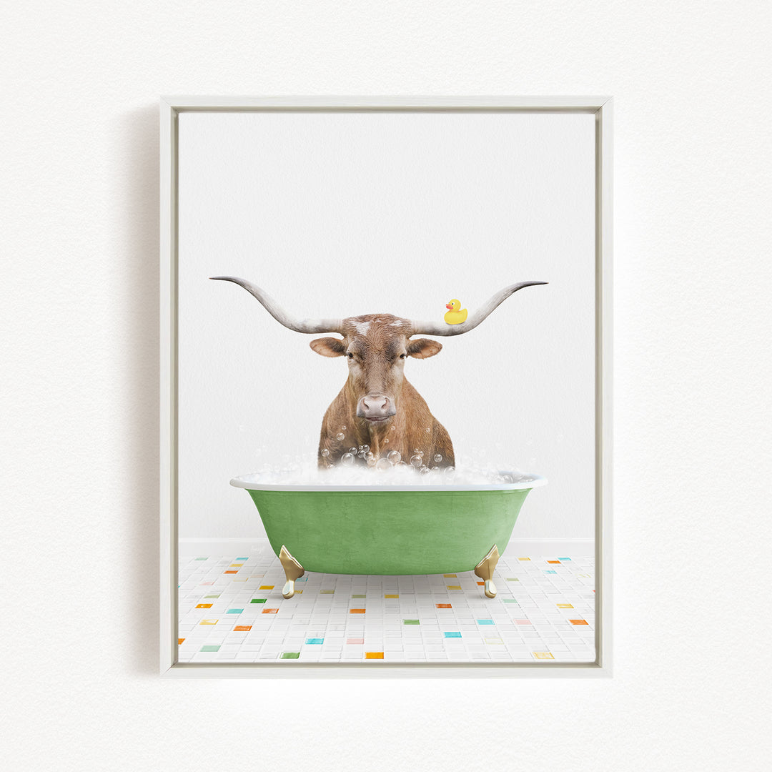 A brown cow with long horns is sitting in a green bathtub filled with bubbles, with a rubber duck floating on the water.