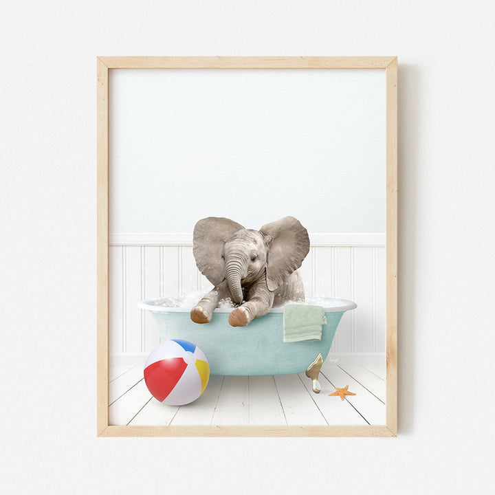 an elephant sitting in a bathtub with a beach ball