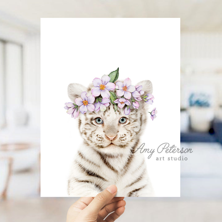 a hand holding a card with a picture of a white tiger wearing a flower crown