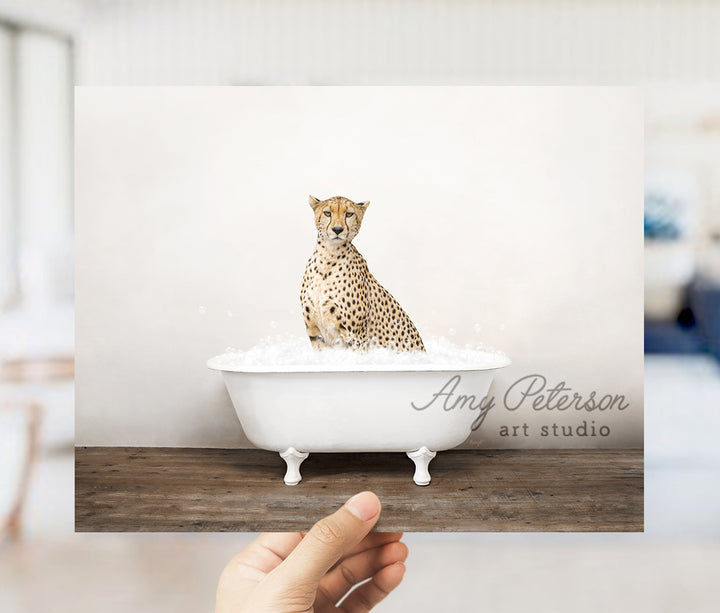 a hand holding a card with a picture of a cheetah in a bath