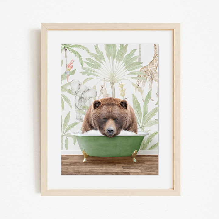 A framed image depicting a brown bear sitting in a green bathtub, surrounded by a tropical jungle scene with various animals and plants.