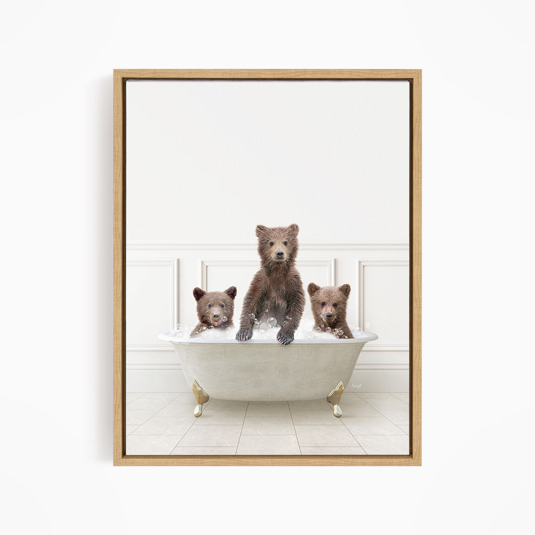 Three brown bears sitting in a white bathtub, with one bear sitting in the center and the other two bears sitting on either side.