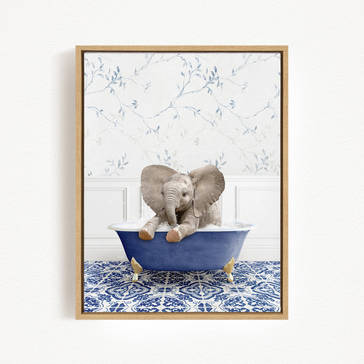 A baby elephant sitting in a blue bathtub, surrounded by a blue and white patterned rug and a floral wallpaper background.