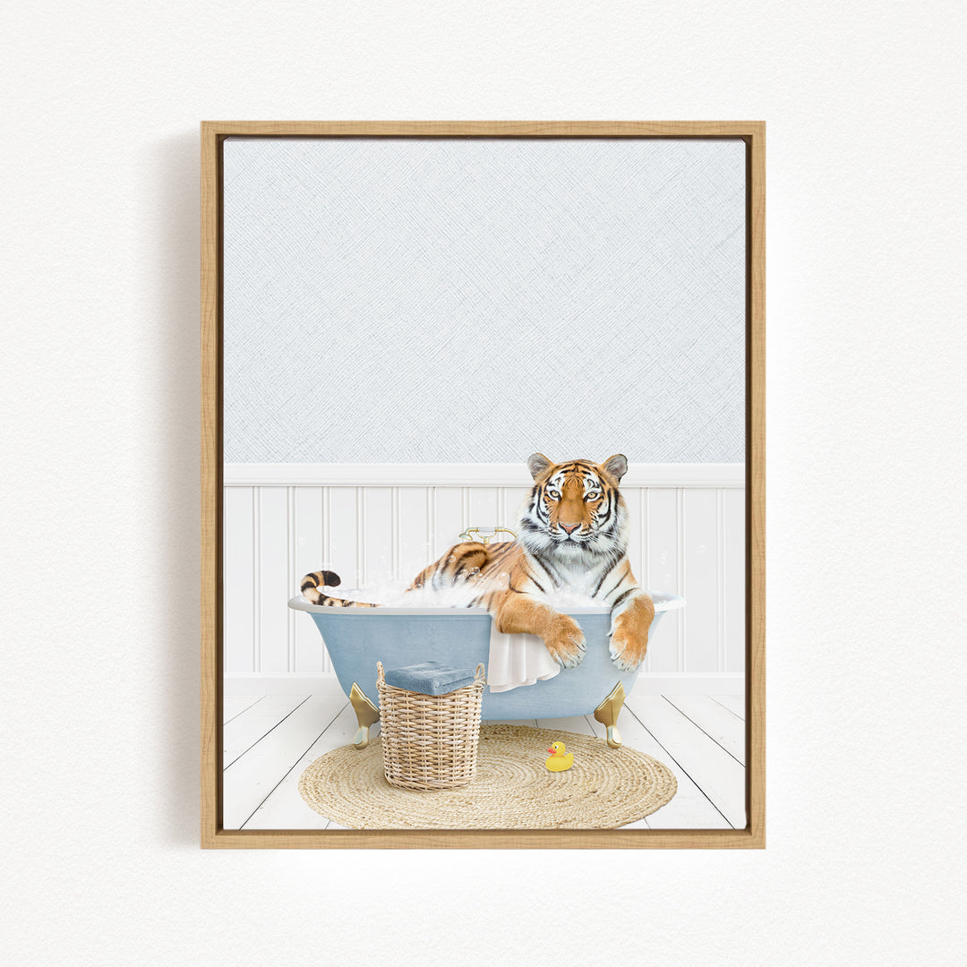 A tiger is sitting in a bathtub filled with water, surrounded by a basket of toys and a yellow rubber duck.