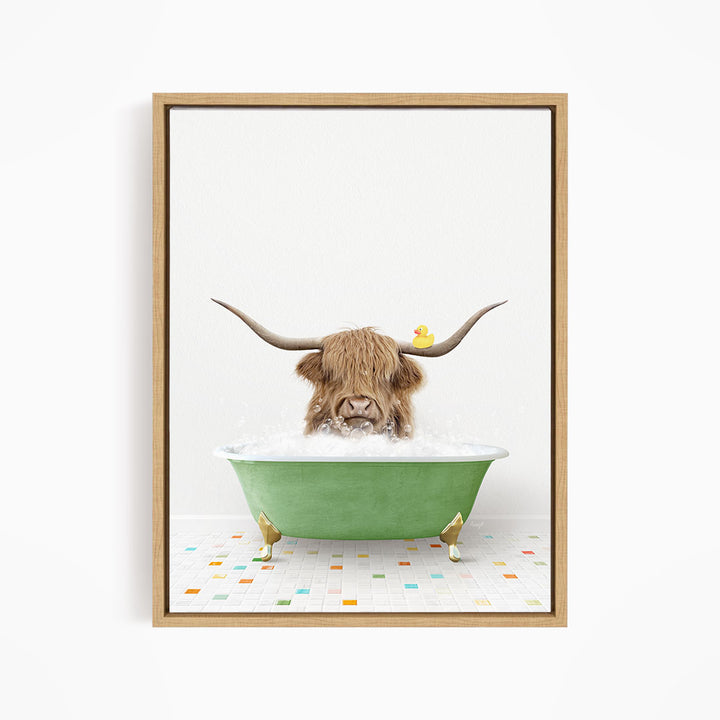 A brown cow with long horns is sitting in a green bathtub filled with bubbles, with a rubber duck floating on the water.
