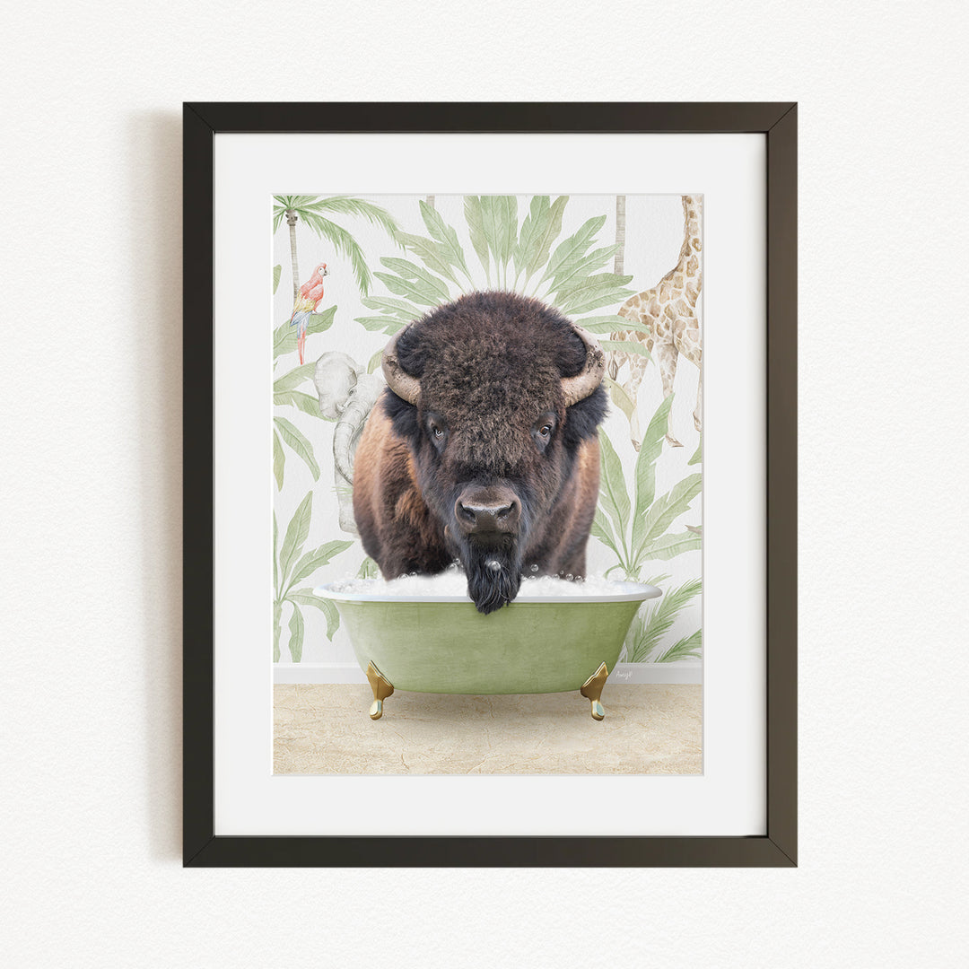 A framed image depicting a bison sitting in a green bathtub, surrounded by a tropical wallpaper with a giraffe and other animals.
