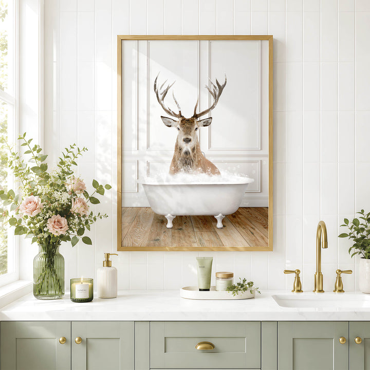 a bathroom with a framed picture of a deer sitting in a bathtub, surrounded by flowers and candles.