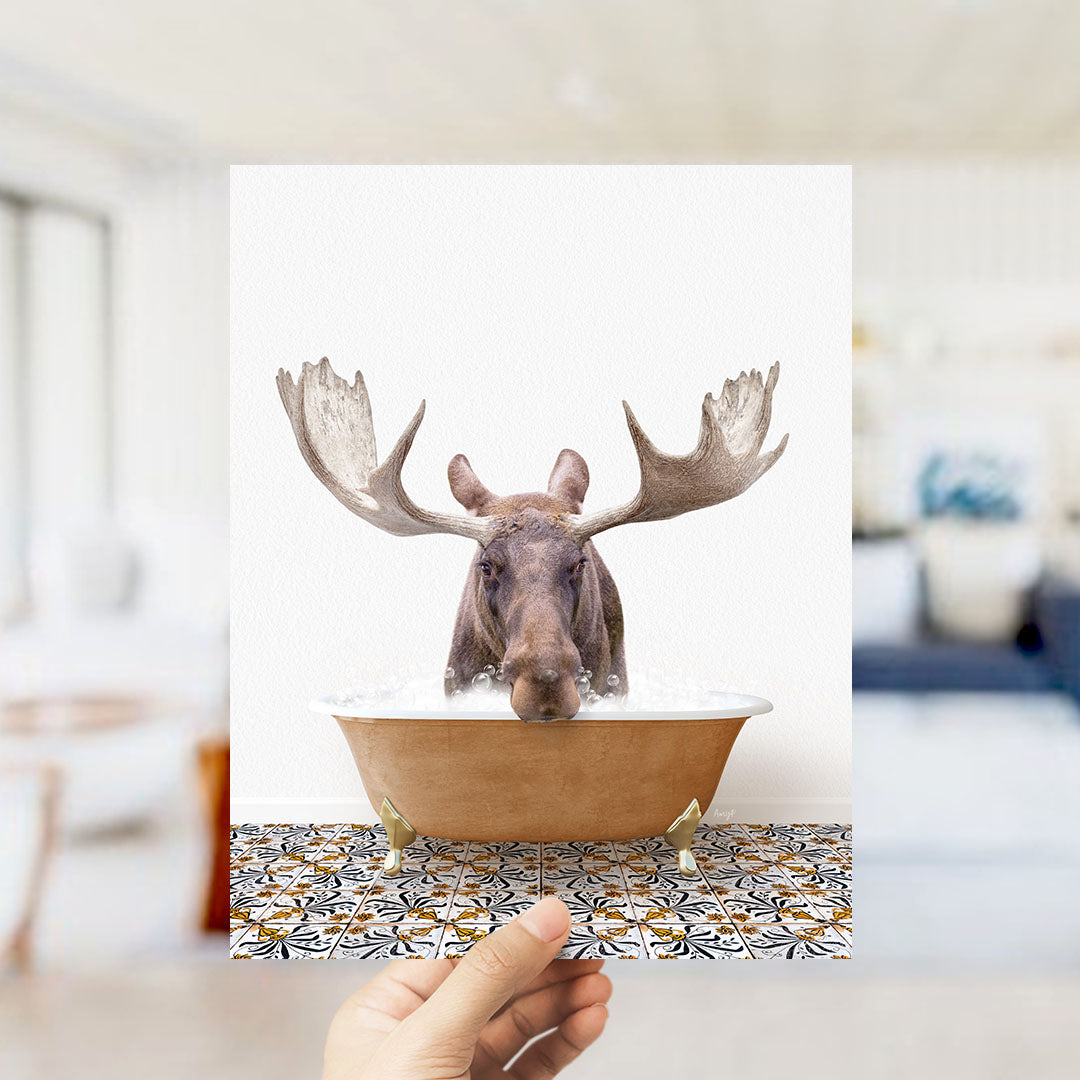 A moose with large antlers is sitting in a bathtub filled with water, creating a whimsical and humorous scene.