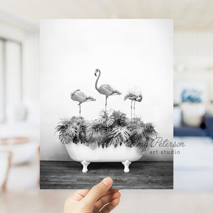 a black and white photo of three flamingos in a bathtub