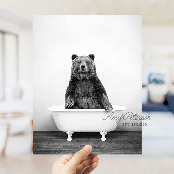 a black and white photo of a bear in a bathtub