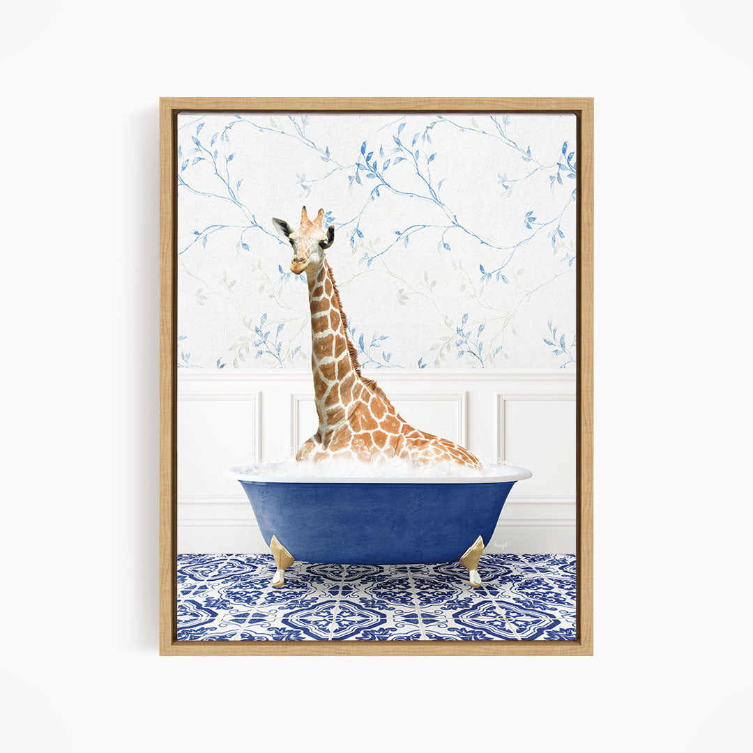 A giraffe is sitting in a blue bathtub, surrounded by a patterned tile floor and a floral wallpaper background.