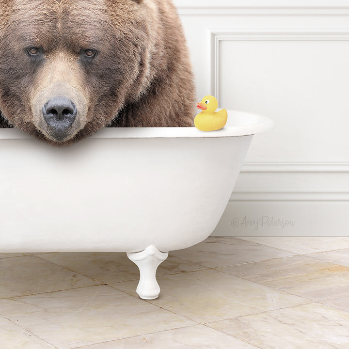 A large brown bear sits in a white bathtub, with a yellow rubber duck resting on the edge of the tub.