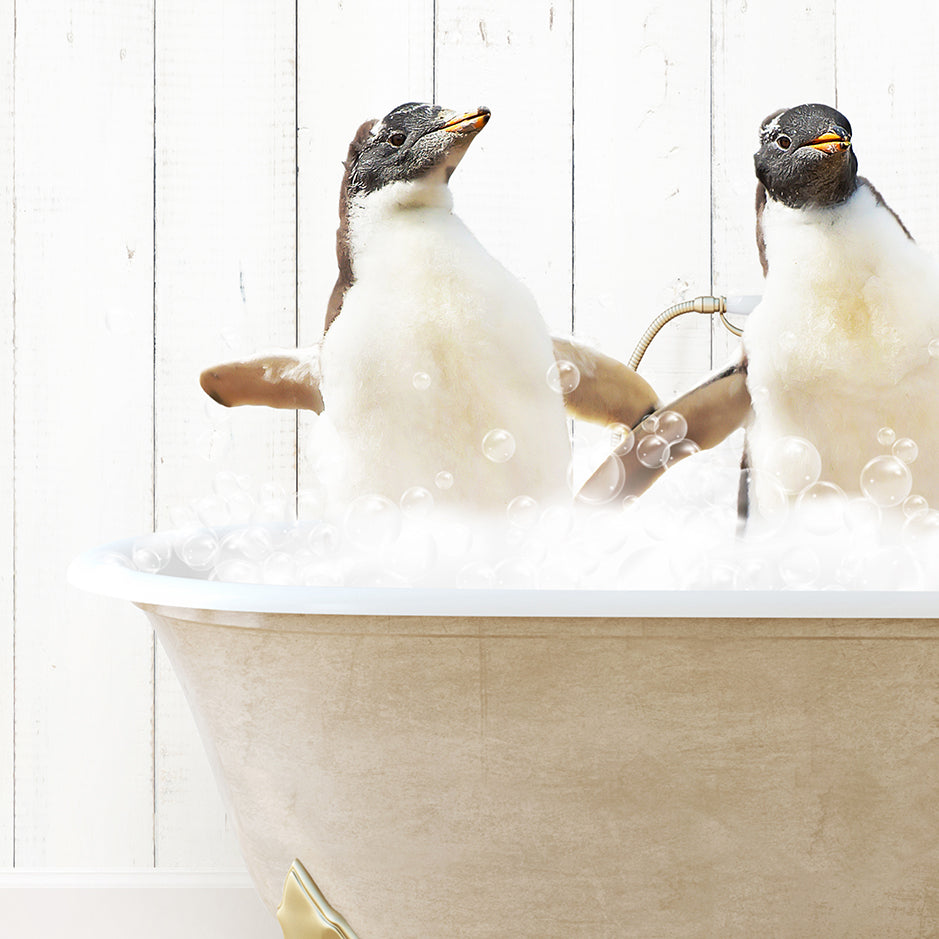 two penguins sitting in a bathtub full of bubbles