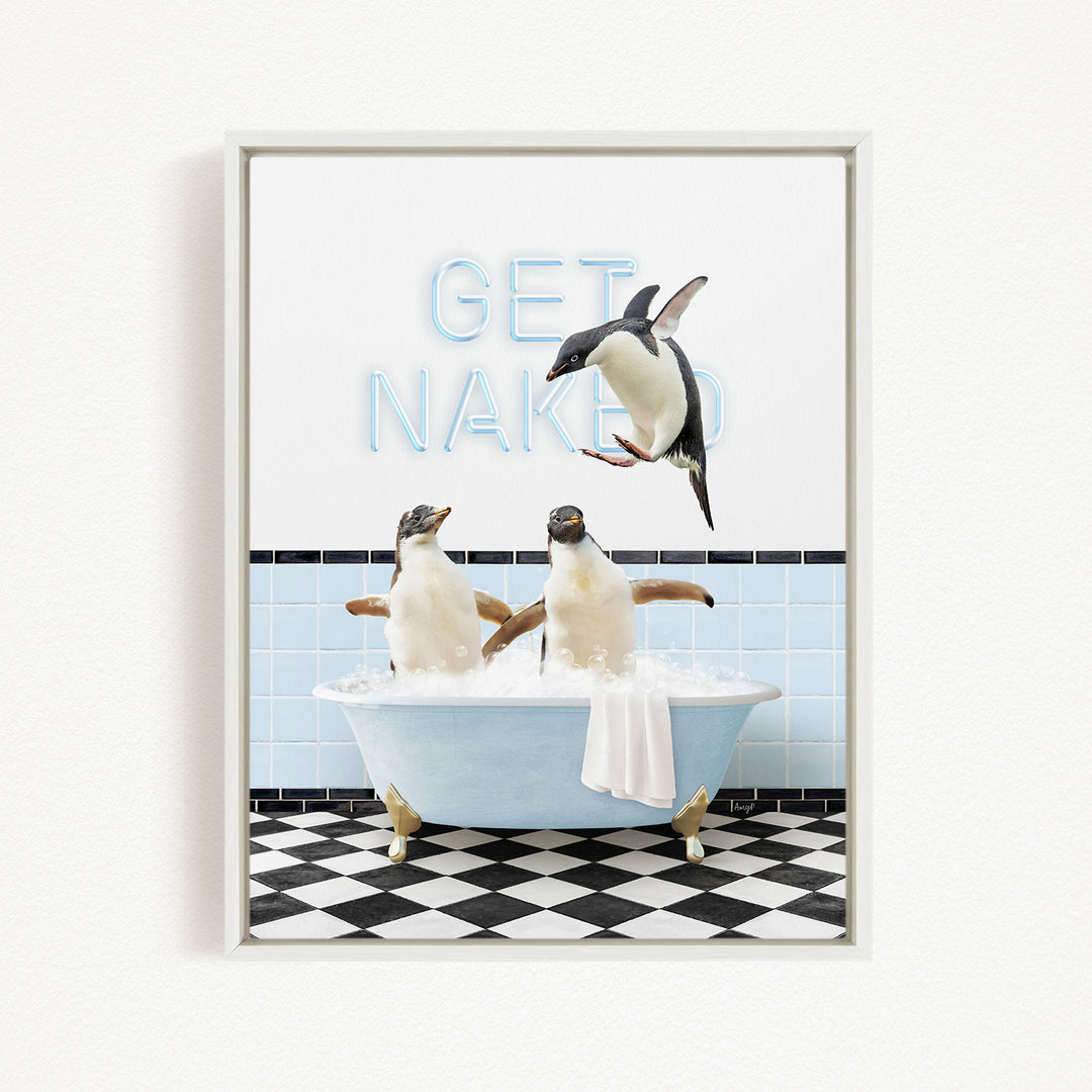 A framed image depicting three penguins sitting in a bathtub, with one penguin jumping out of the tub and the other two penguins sitting in the water.