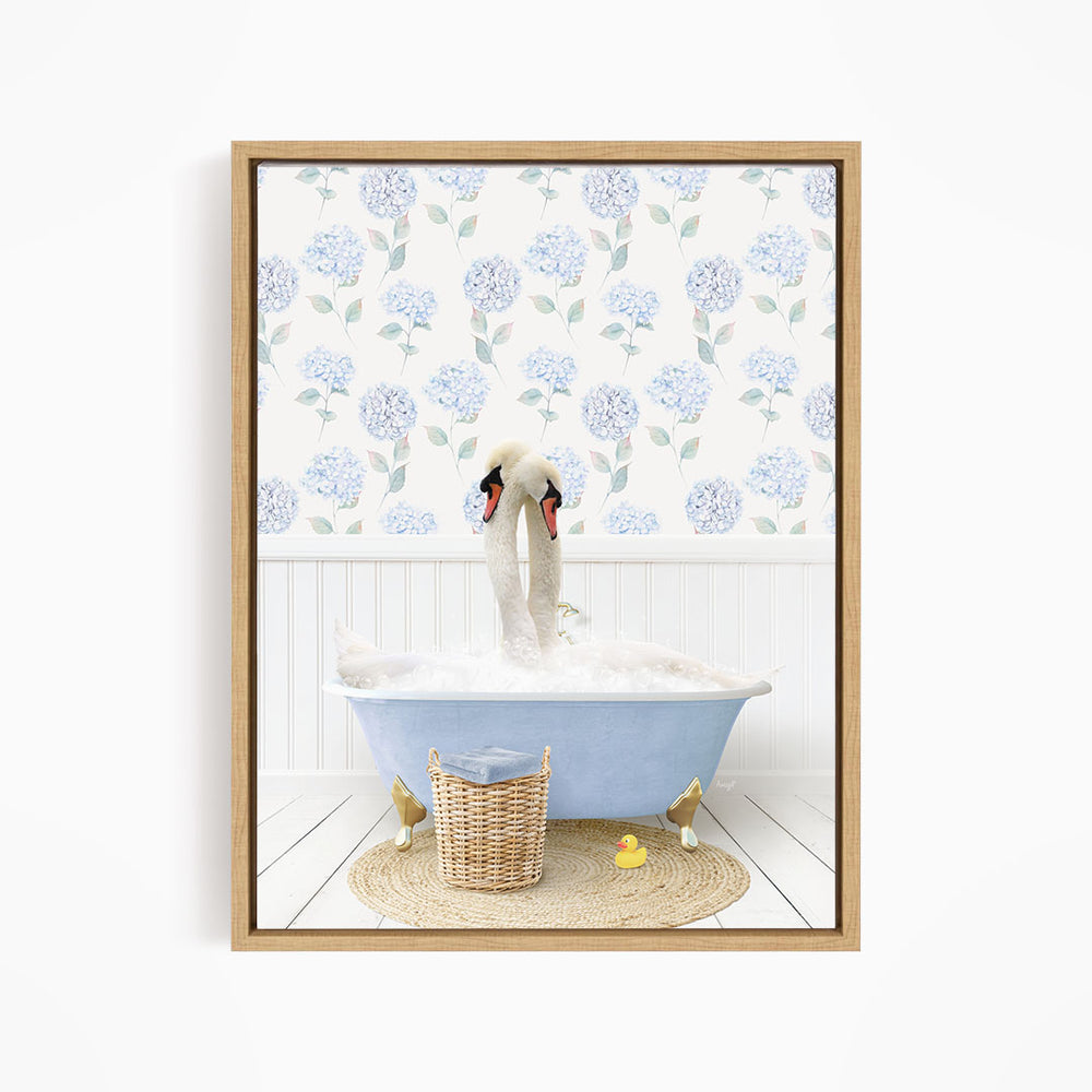 A framed image depicting a white swan sitting in a blue bathtub filled with bubbles, surrounded by a wicker basket and yellow rubber ducks.