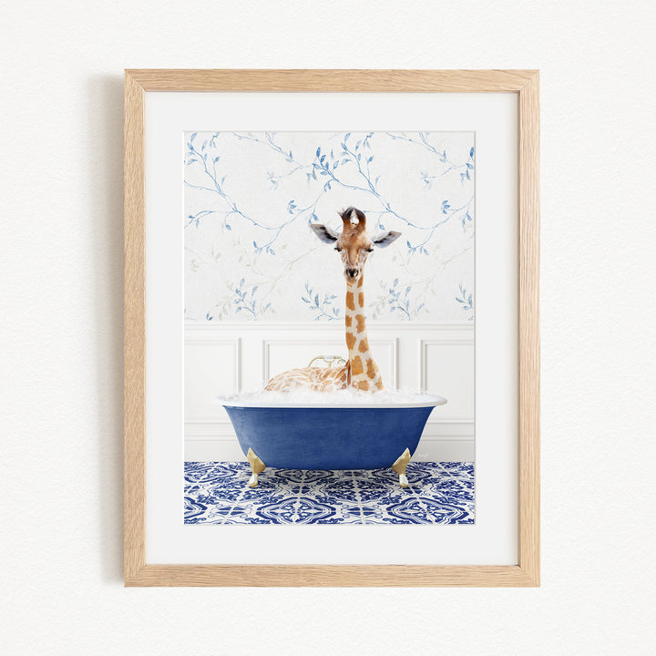A giraffe is sitting in a blue bathtub filled with water, surrounded by a patterned tile floor and a white wall with blue floral wallpaper.