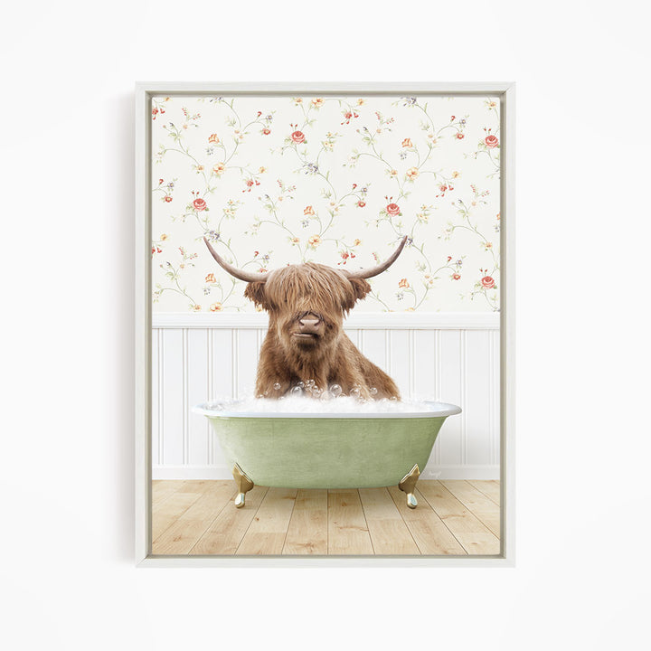 A Highland cow with shaggy hair is sitting in a green bathtub, surrounded by a floral wallpaper.