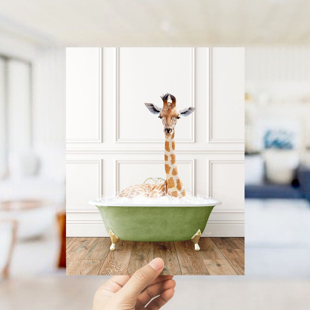 A giraffe sitting in a green bathtub filled with bubbles, with a blurred background suggesting a living room setting.