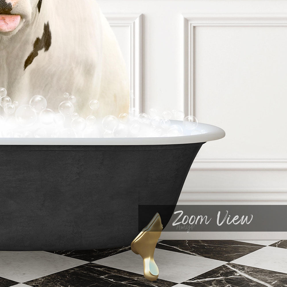 A white cow is sitting in a black bathtub filled with bubbles, with a gold bathtub leg visible on the floor.