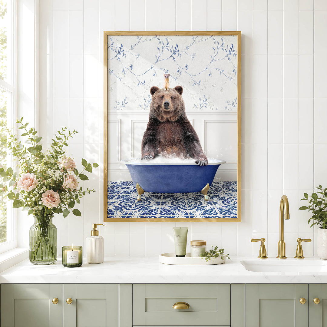 a framed picture of a bear sitting in a bathtub, surrounded by various bathroom decor items such as a vase of flowers, candles, and a tray with a cup and a bottle.