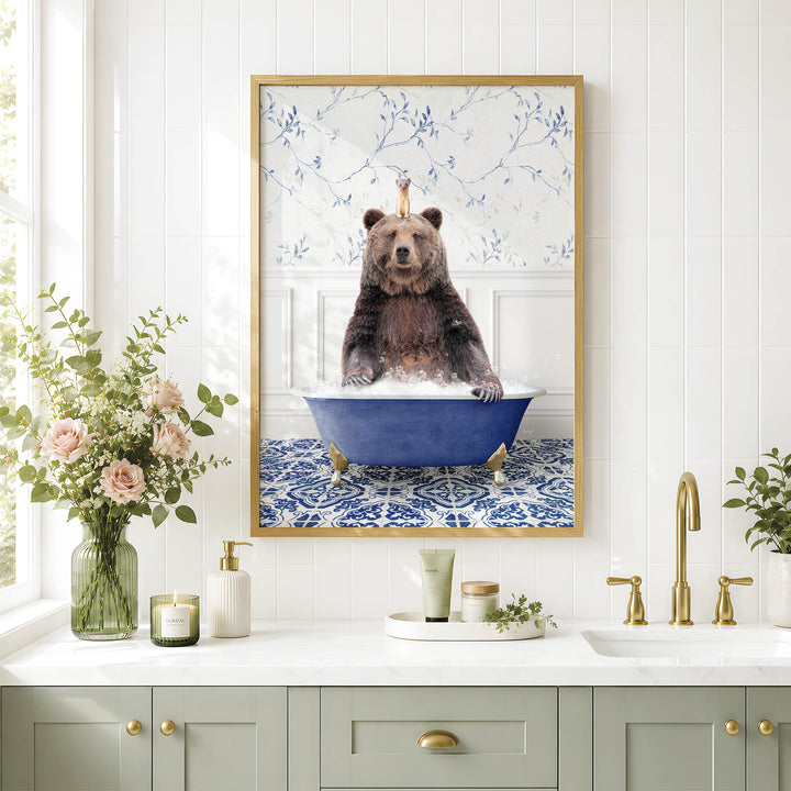 a framed picture of a bear sitting in a bathtub, surrounded by various bathroom decor items such as a vase of flowers, candles, and a tray with a cup and a bottle.