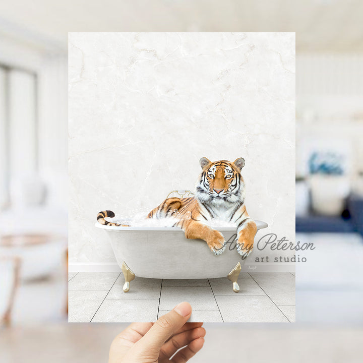 a hand holding up a picture of a tiger in a bathtub