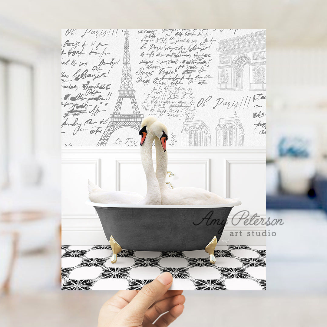 a person holding up a card with a picture of a swan in a bathtub