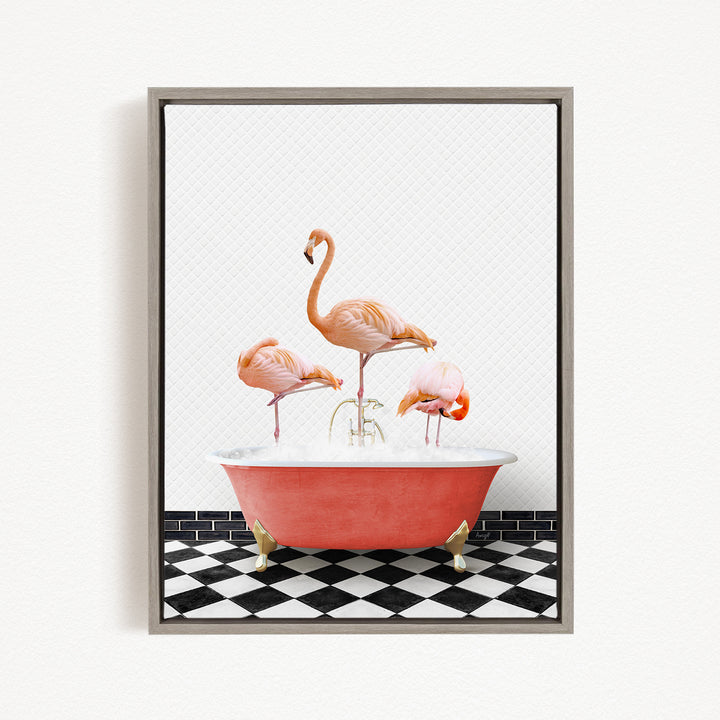 A framed image depicting three pink flamingos standing in a red bathtub on a black and white checkered floor.