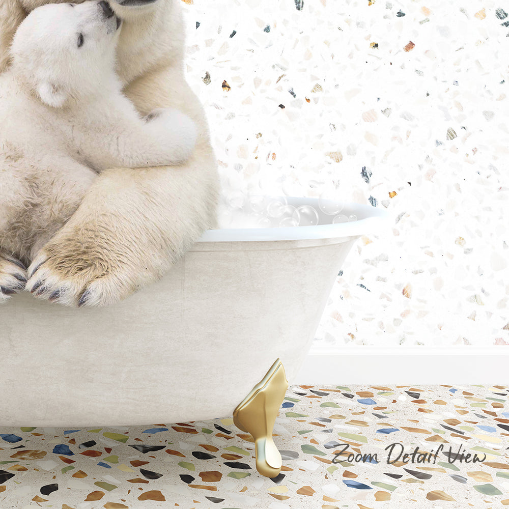 A polar bear cub sitting in a bathtub, with another polar bear cub sitting on top of it.