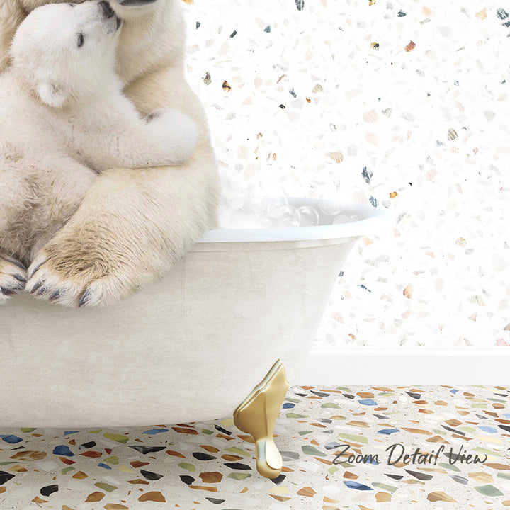 A polar bear cub sitting in a bathtub, with another polar bear cub sitting on top of it.